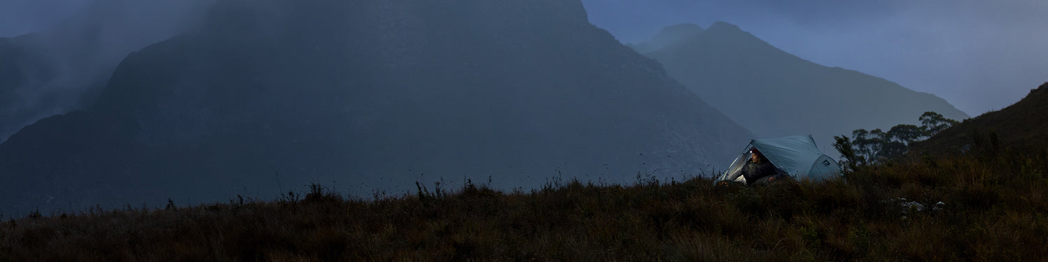 Man sits in the award winning, ultralight Telos Tent